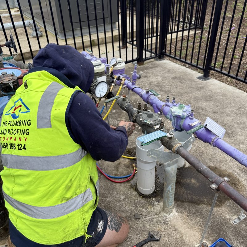 Plumber working on recycled water pipework