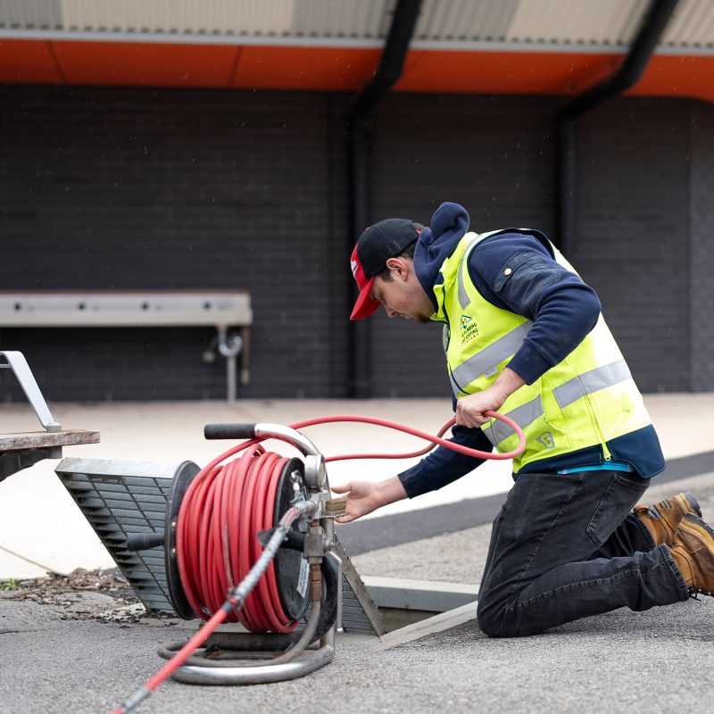 Plumber jetting a blocked drain