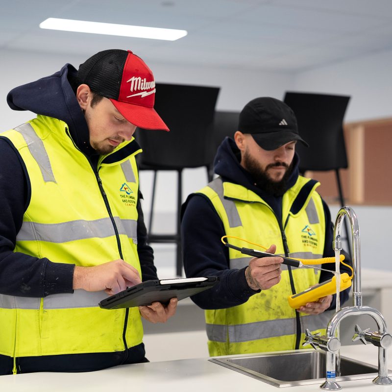 Plumbers assessing a job and providing a quote