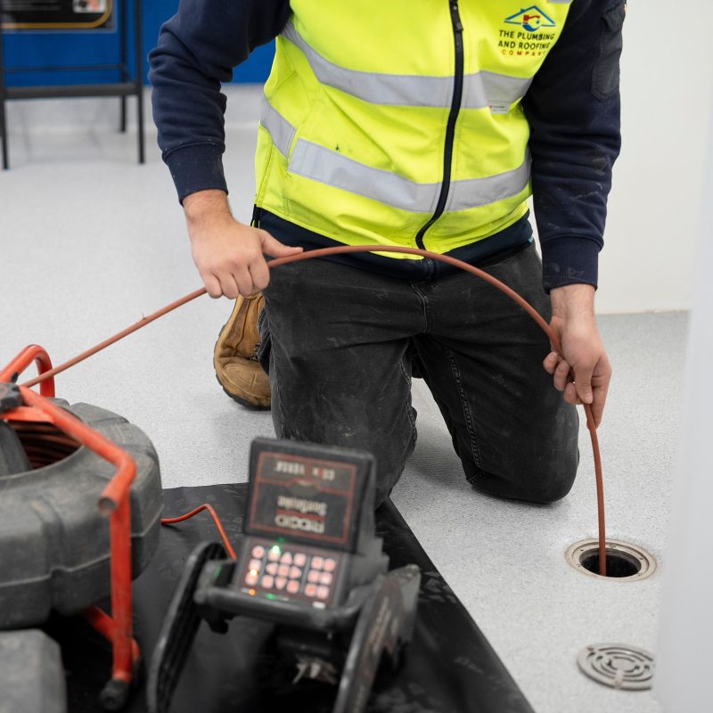 Plumber clearing a blocked drain