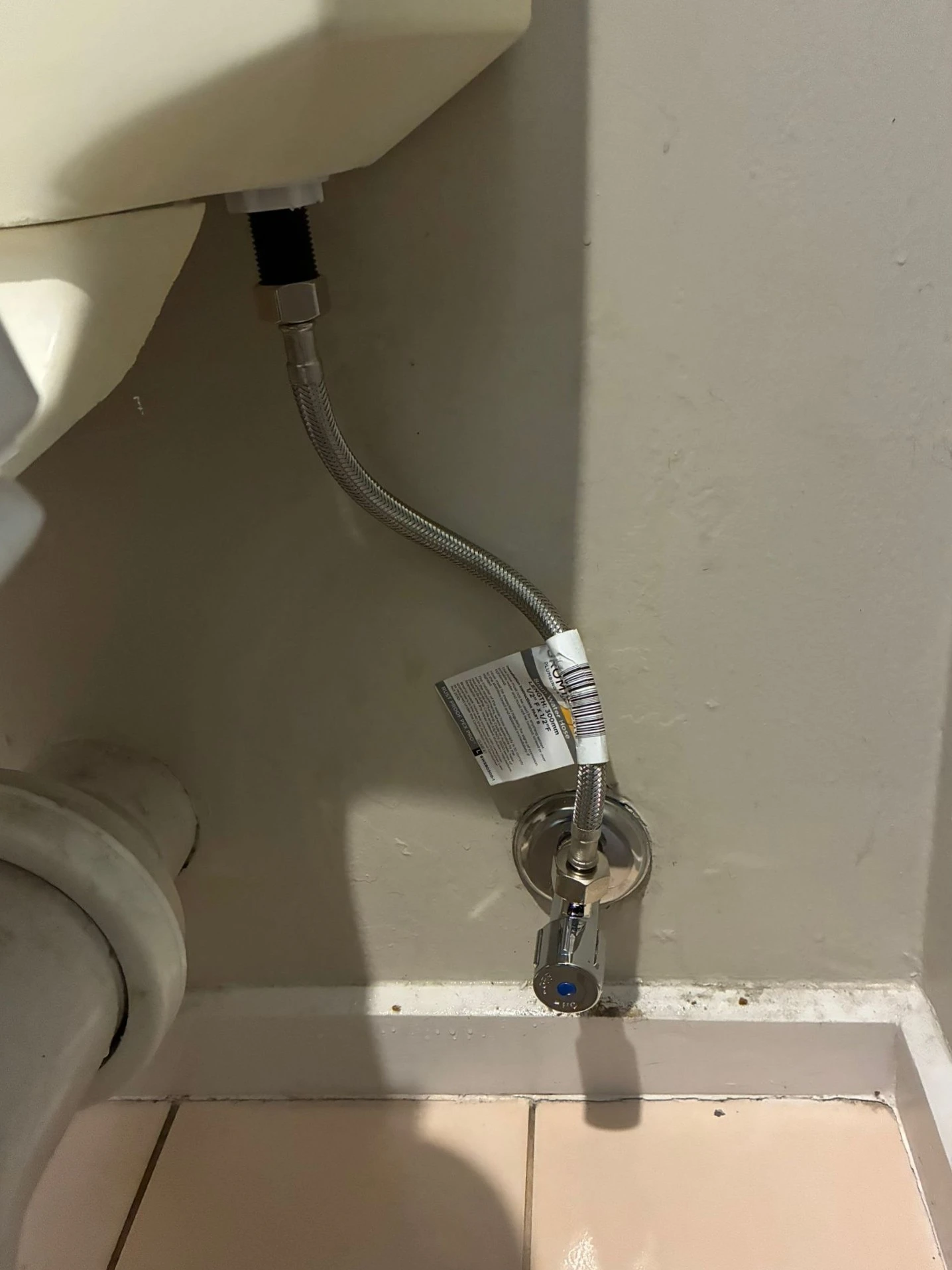 After: new braided stainless steel flexi hose at the toilet cistern