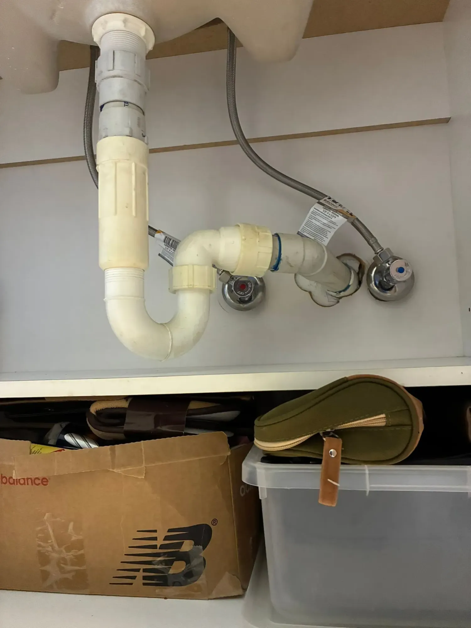 After: new braided stainless steel flexi hoses under a basin